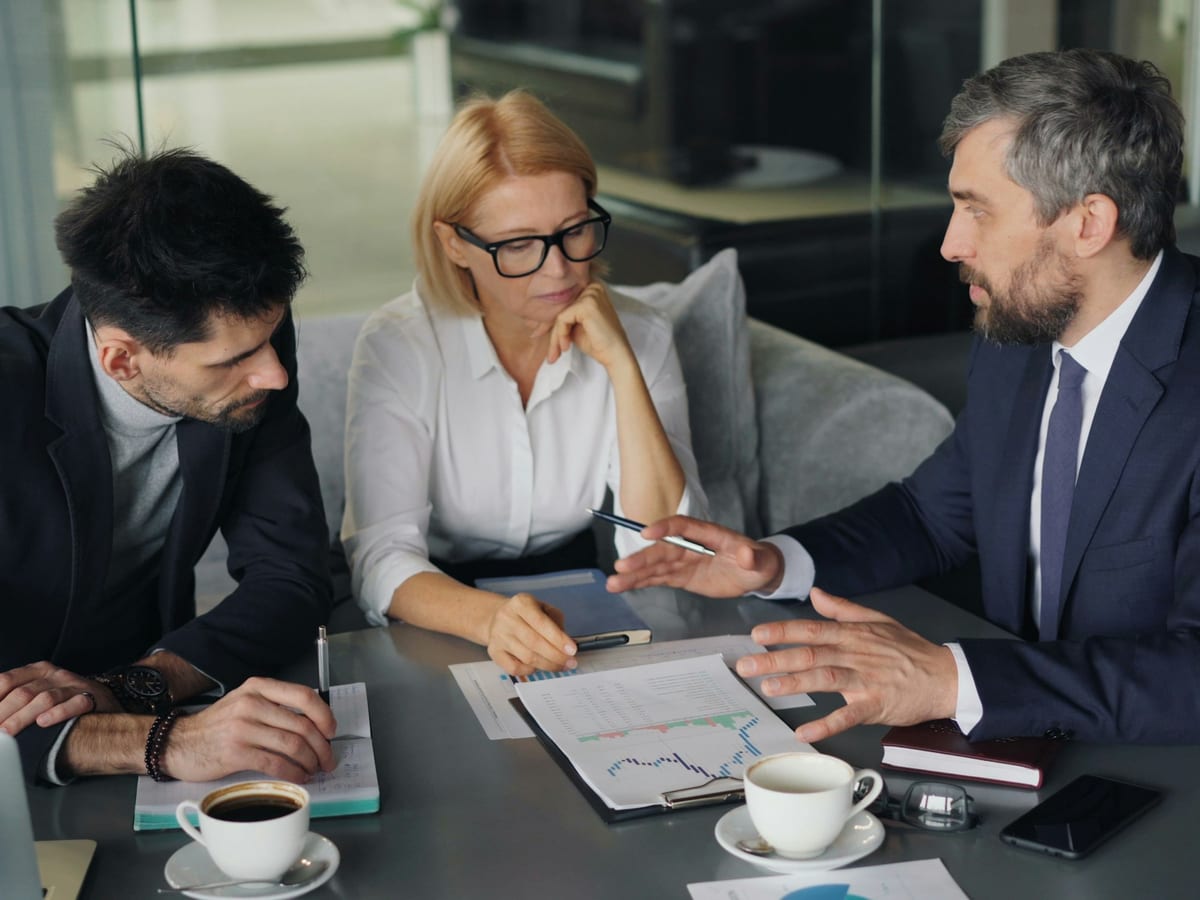 Finance team reviewing charts together at a conference table