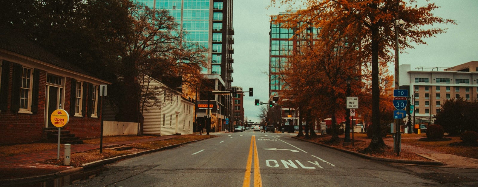 Downtown Little Rock street with historic houses and glass high-rises