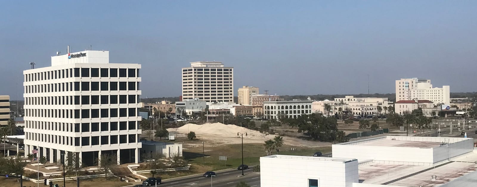 Downtown Gulfport's office towers and low blocks under a clear Gulf Coast sky