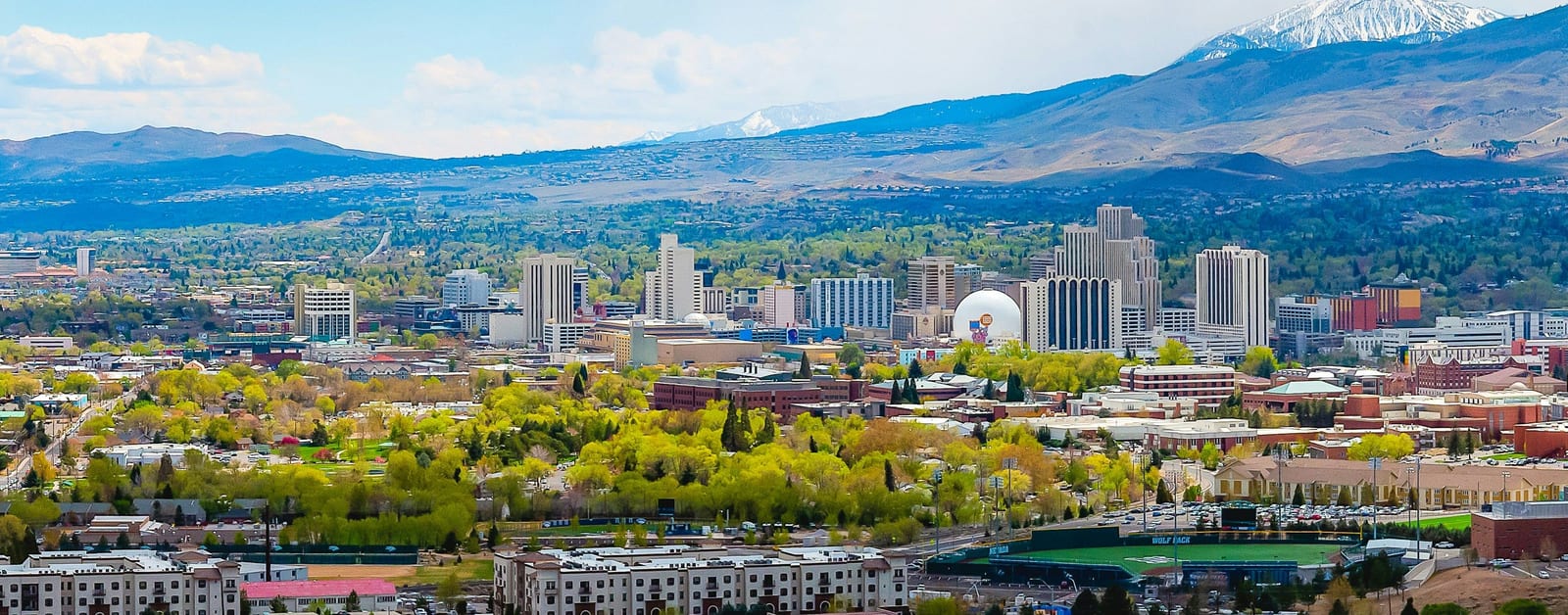 Panorama of downtown Reno high-rises and the University of Nevada campus below the Carson Range