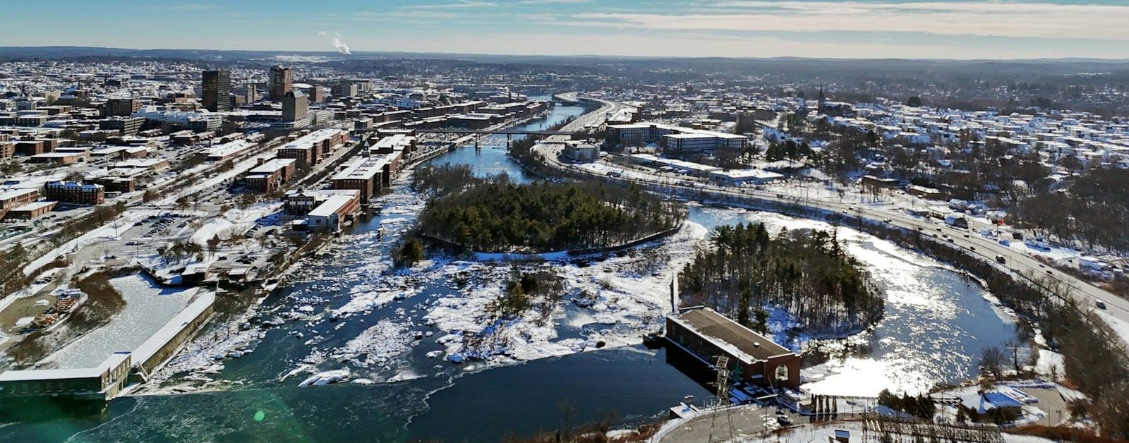 Aerial view of Manchester in winter with the frozen Merrimack River at Amoskeag Falls and downtown