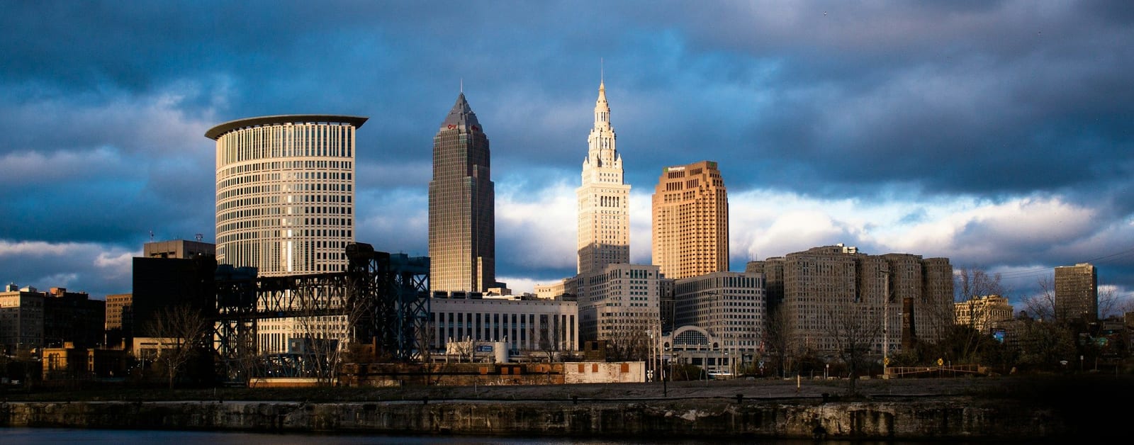 Cleveland skyline with Terminal Tower and Key Tower across the Cuyahoga River under storm clouds