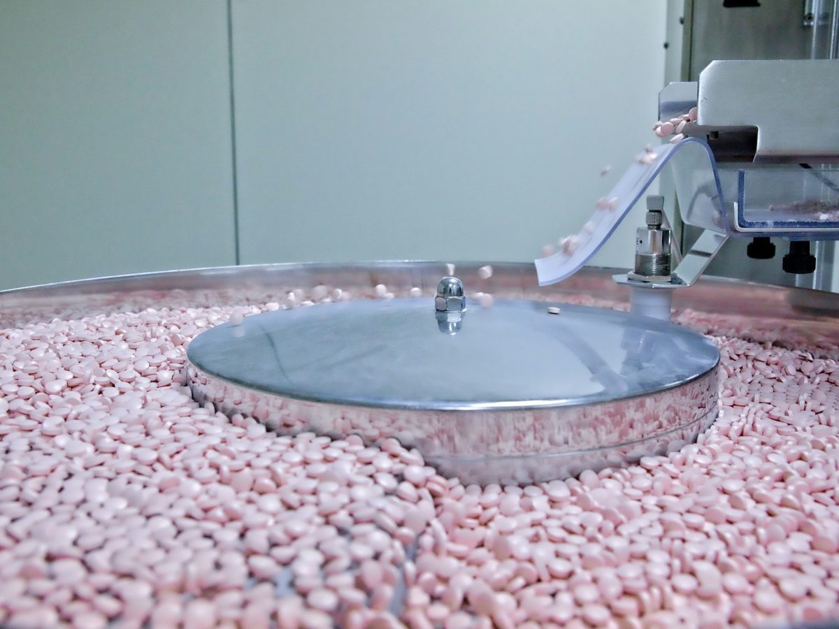 Tablets feeding across the rotating disc of a high speed counting machine