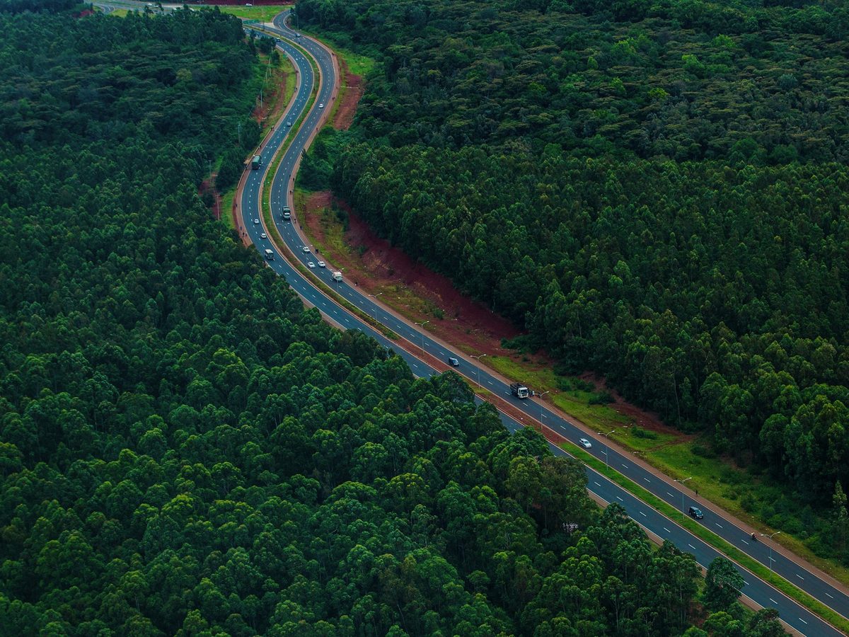 Aerial view of a highway running through forested country
